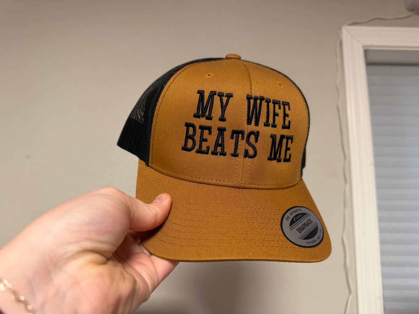 “My Wife Beats Me” Embroidered Trucker Hat - Brown/Black
